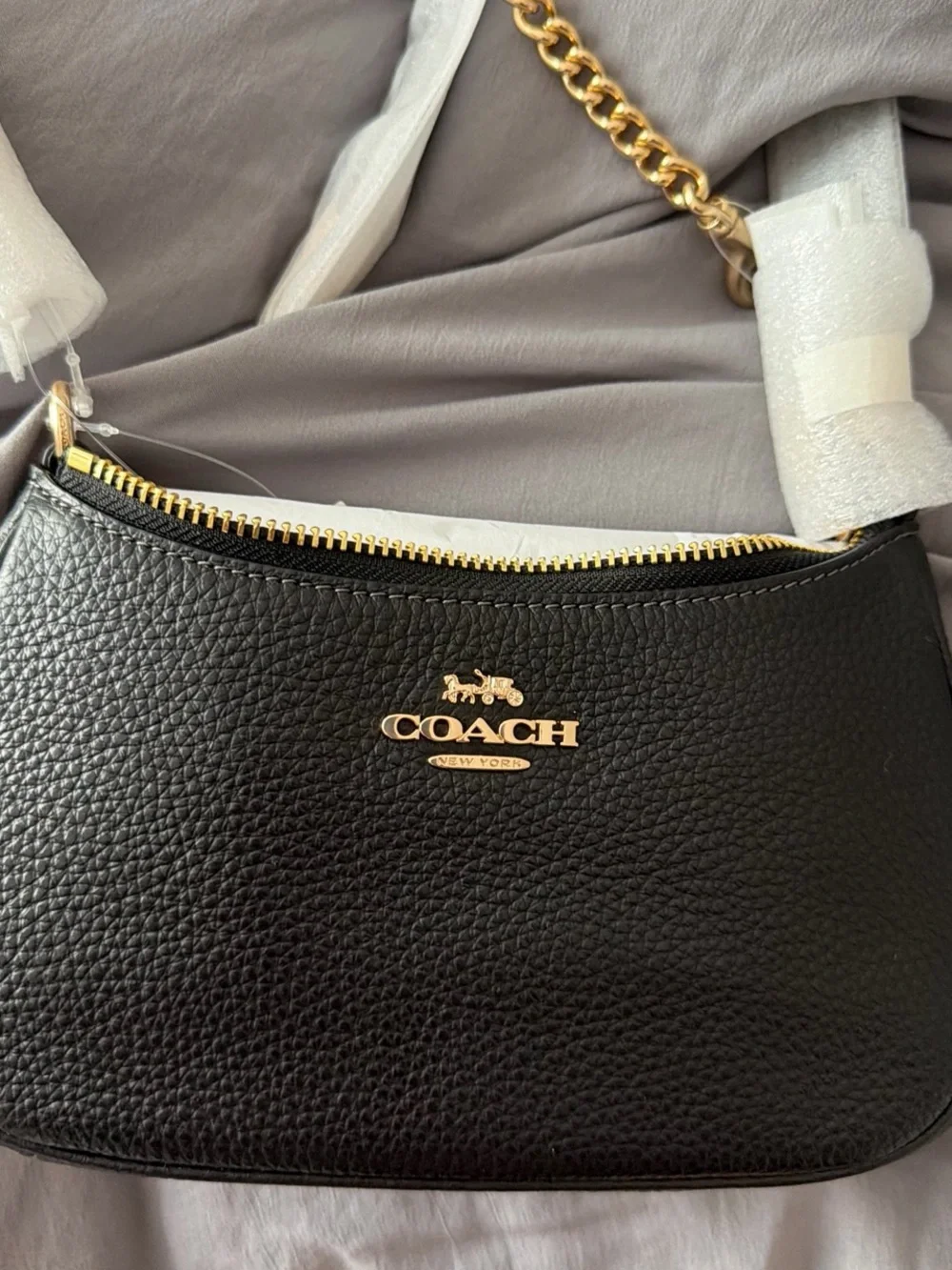 COACH Teri Mini Black Pebbled Leather Shoulder Bag with Gold Hardware.